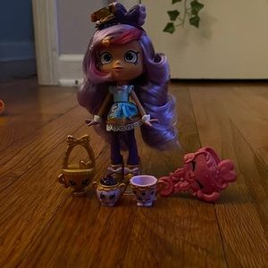 Tea Cup Shopkin Doll. Color - Purple. Comes with 2 shopkins, purse, and brush.